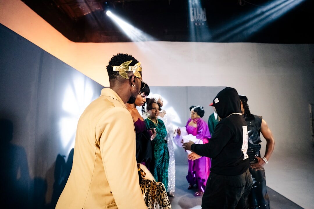 Stylist adjusting a gown backstage before a fashion event